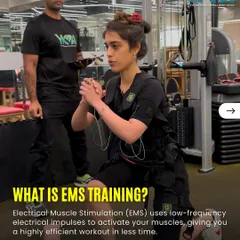 What is EMS training? It uses safe, low frequency electrical impulses to activate your muscles more deeply than conventional training, giving you a highly efficient workout. Here, a trainer guides a client through a lunge, ensuring perfect form.