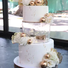 I love adding a modern twist to classic designs. This three-tier cake features a clear acrylic spacer filled with twinkling fairy lights, giving it a magical, floating effect perfect for an evening reception.
