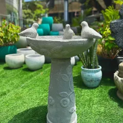 Invite nature into your garden with our pristine, hand-carved bird baths. This piece features a floral-patterned pedestal and three charming birds perched on the rim, making it both a functional and beautiful addition.