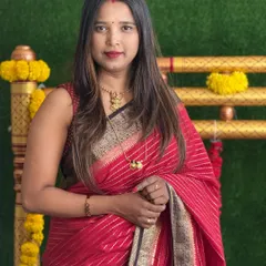 A professional portrait of me in a classic red saree.