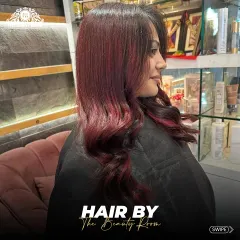 A beautiful example of a red balayage, where the color melts from a darker root to vibrant red ends. This technique ensures a graceful grow-out.