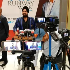 Here I am at Delhi Runway Week, addressing the media. I'm wearing a custom blue and black striped blazer, a piece that reflects my personal philosophy: be bold and make your own rules.