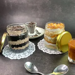 My jar cakes are a key component of the gift hampers and are also available individually. I offer them in popular flavors like this rich chocolate chip and a sweet caramel crunch, layered for a perfect spoonful every time.