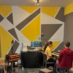 A student receives one-on-one guidance during a music production class at our Kaggadasapura studio. We focus on practical learning, using keyboards and software to bring musical ideas to life.