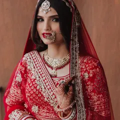 There is a unique power in a classic red lip. This close-up shows how a perfectly applied bold red lipstick can define a bridal look, making it both timeless and unforgettable.