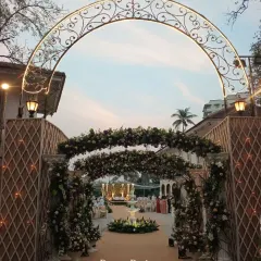 Your guests' experience begins the moment they arrive. I crafted this grand entrance with a wrought-iron arch and lush floral arrangements to set a tone of classic elegance and welcome everyone into a beautifully styled celebration.