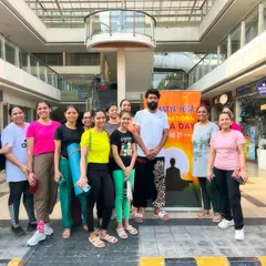 Our core group posing in front of our banner for the International Yoga Day event. It was a day filled with positive energy and community spirit.
