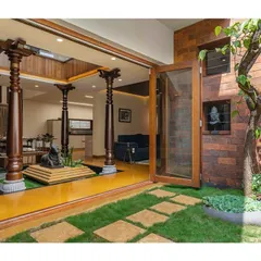 The indoor courtyard opens up completely to a private garden, merging the interior and exterior spaces into one cohesive, peaceful environment.