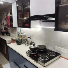 Another angle of the Paras Tieria kitchen, showing the practical layout with the hob, chimney, and ample counter space. We use trusted brands to ensure durability and performance.