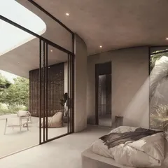 A bedroom in the House of Veils opens onto a private terrace through large sliding glass doors. The room is designed with curved walls and screened windows that filter light, creating a soft and moody atmosphere.