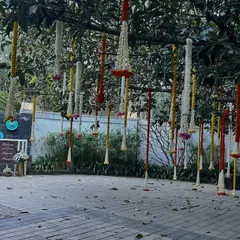 This image shows the entrance area with the hanging floral decorations on the tree and a welcome sign in the background. It demonstrates how we tie different decorative elements together for a cohesive look.