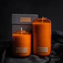This is my Volumetric Curve candle in a warm orange hue, perfect for adding a pop of color to your decor. It comes in a simple grey gift box, making it a stylish and contemporary present.