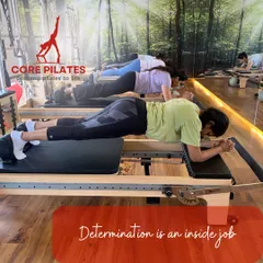 Determination is an inside job, but a supportive group makes it easier. Our clients hold a strong forearm plank on the reformer, building endurance and total-body strength together.