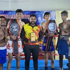The team celebrating two title belts at the K1 Kerala State Kickboxing Championship. We are proud to bring these championships back to Karnataka.