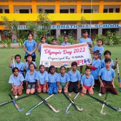 My sub-junior players with their sticks crossed, ready for their Olympic Day tournament. It's all about having fun and learning the basics of the game.