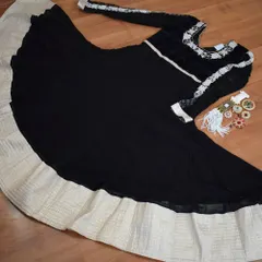 I designed this black and white Anarkali for a client who wanted timeless elegance. The flowing georgette is contrasted with delicate white embroidery on the sleeves and yoke, creating a look that is both classic and striking.