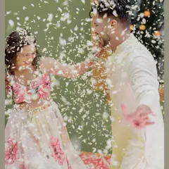 A dynamic shot of the couple playfully showering each other with flower petals during their floral-themed haldi, a moment of pure fun.