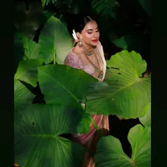 This artistic shot captures the essence of a soft and natural engagement look. The makeup was completed in just one hour, focusing on a dewy, glowing finish that enhances the bride's natural radiance, perfect for an outdoor setting.