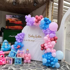A colorful and fun baby shower setup for "Baby Kuba," featuring "BABY" blocks and a mix of pink, blue, and purple balloons.