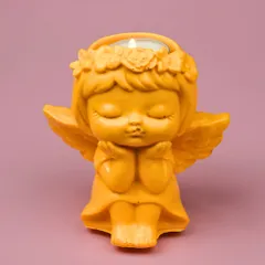 The angel figurine shown here as a tea-light holder. The warm glow of the candle brings out the peaceful details of the handcrafted Jesmonite piece.