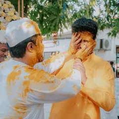 A candid moment of fun between the groom and his friend or brother during the Haldi ceremony. It's these unposed interactions that show the true spirit of the day.