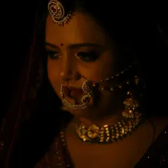 This shot highlights the intricate details of the bridal jewelry, like the nath and maang tikka, and how the makeup works in harmony with them to complete the look.
