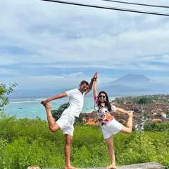 Bali bound. Finding balance together with a partner Natarajasana (Dancer's Pose) overlooking a stunning Bali landscape. Yoga is a journey best shared.