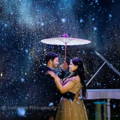 Imagine a romantic moment under the stars, captured in our special artificial rain setup. This unique effect, combined with the elegant piano prop, creates a truly magical and cinematic pre-wedding photograph.