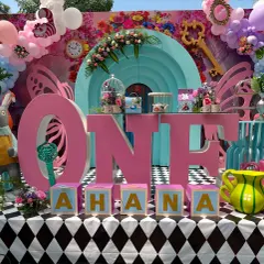 A closer view of the main table for 'Ahana's Onederland'. The setup included a White Rabbit prop, personalized name blocks, and other iconic elements from the story to create a perfect photo opportunity.