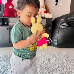 This little boy loves his new yellow bunny. My toys are soft and safe, perfect for children to hold and cuddle.