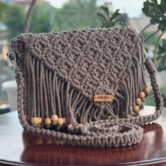 My boho-style fringed sling bag is one of my most popular designs. I make it with soft, eco-friendly cotton cord, and it's perfect for adding a touch of handmade charm to any outfit. This beautiful brown shade is a classic.