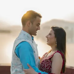 A close-up shot capturing a happy, natural moment between the couple, with the soft light of the sunset creating a warm and romantic atmosphere.