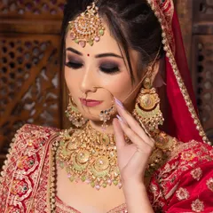 A close-up of a traditional red bridal look with bold, smokey eyes and perfectly defined lips, created by a student during their 45-day makeup course.