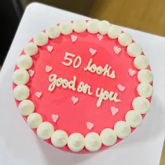"50 looks good on you." A simple, chic, and minimalist bento cake that makes a sweet statement for a milestone birthday.