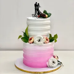 Featured by WeddingWire India, this two-tier ombre pink cake is one of my most requested designs. The gradient effect, combined with fresh flowers and a couple topper, creates a look that is both modern and romantic.