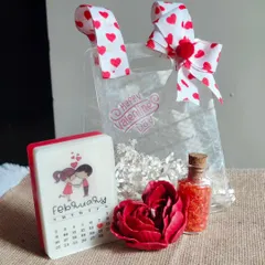 A romantic Valentine's Day gift set, including a calendar soap marking the special day, a rose candle, and bath salts.
