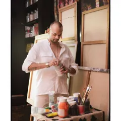 Artist Pushkar Thakur at work in his studio, mixing paints. I love documenting the creative process and the hands-on work that goes into making art.