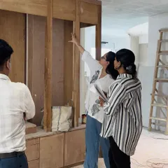 An architect on site, inspecting the woodwork and joinery for a custom storage unit. We conduct regular quality checks to ensure the craftsmanship meets our high standards and the design intent is perfectly realized.