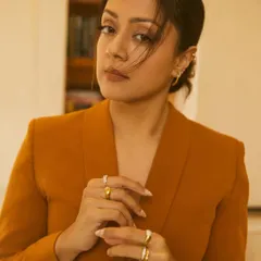 A close-up on the accessories for Jyotika's look, showing a curated stack of gold rings and delicate ear cuffs that add an edge.