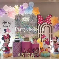 A pastel Minnie Mouse theme perfect for a magical birthday. This setup features a shimmering silver sequin backdrop, a multi-colored pastel balloon arch, and life-sized cutouts of Minnie, Daisy, and Pluto, all personalized with the birthday girl's name in light-up letters.