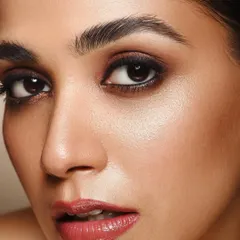 A powerful and direct shot from the 'Kaia' series. The focus is entirely on the eyes and the expert makeup, showing how lighting can be used to create depth and intensity in a beauty portrait.