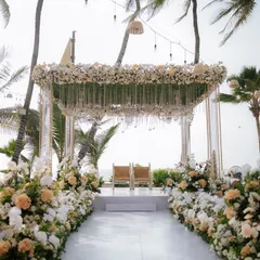 A breathtaking beachside mandap that perfectly blends elegance with nature. We used a canopy of white and peach florals with hanging crystals to create a dreamy ceremony space.