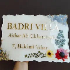 Another angle of the floral resin nameplate, showing how the gold lettering catches the light. Each nameplate is fully customizable with names, addresses, and your choice of colors and flowers.