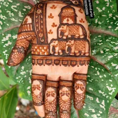A close-up of a hand design featuring a family of elephants under a royal canopy. The fingers are detailed with small peacock heads, showing how I love to fill every space with meaningful and beautiful art.