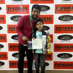 A proud teacher stands with our Radio Mirchi Spardha Idol winner. We provide dedicated mentorship to help our students excel in competitive environments.