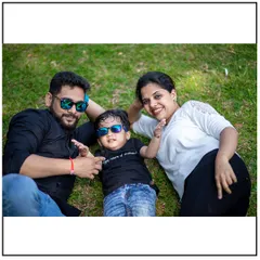 A fun, casual family photo taken from a different perspective. Lying on the grass together is a great way to get everyone to relax and let their personalities show.