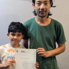 Well done, Samyak. He proudly holds his certificate after passing the RSL Acoustic Guitar graded exam with Merit. This is a fantastic step on his musical journey.