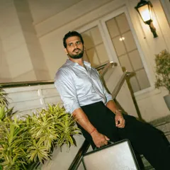 An evening on-location shoot, using architectural lighting to create a sophisticated atmosphere. The model's pose on the staircase with a briefcase tells a story of a modern professional.