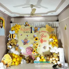 Another angle of our bumble bee party setup, showing the full backdrop, balloon garlands, and the light-up number prop.