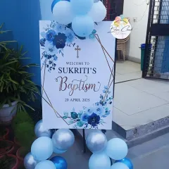 A personalized welcome sign for Sukriti's Baptism. We can create custom signs for any religious ceremony or family milestone, complete with matching balloon decor.